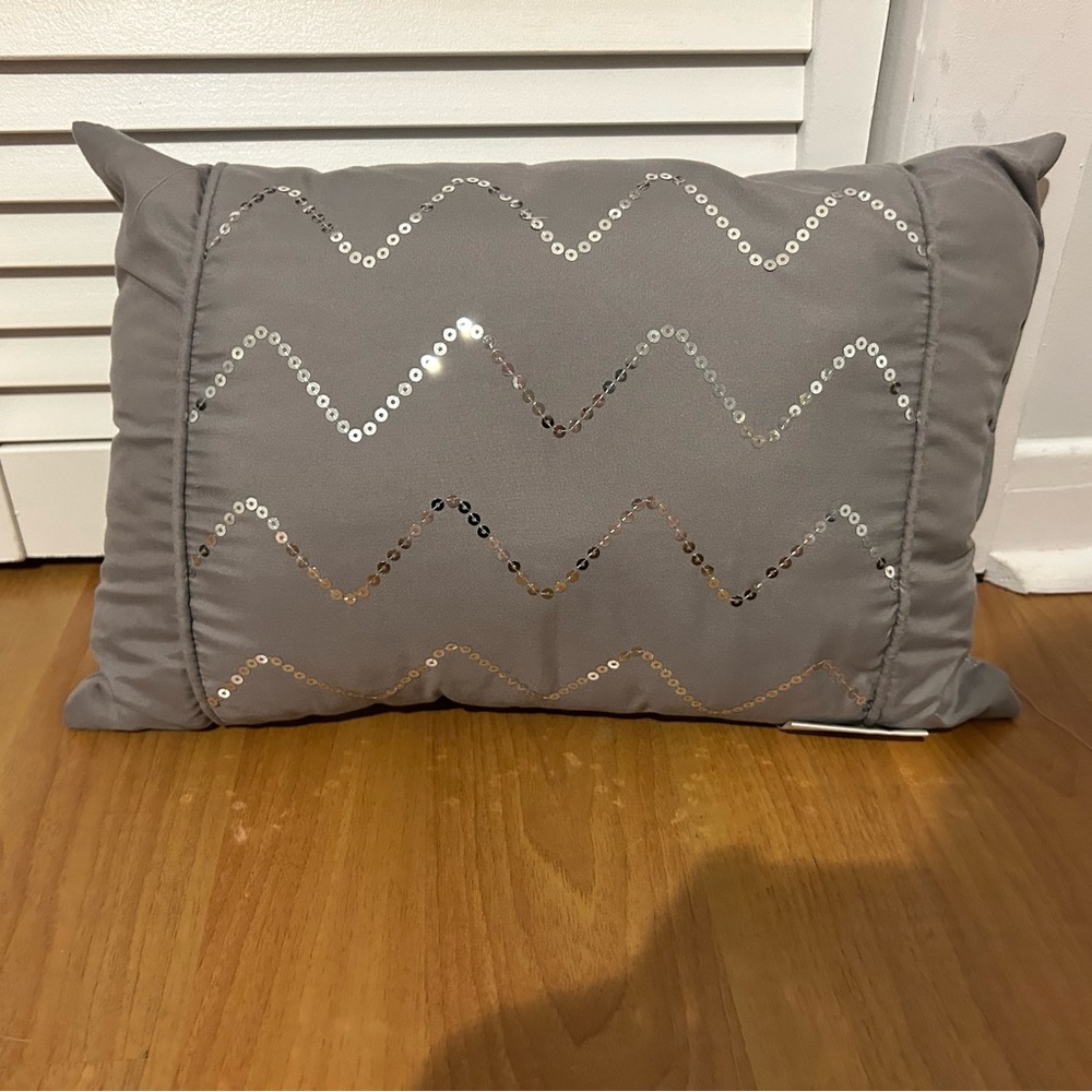 Grey decorative throw pillow with glitters.